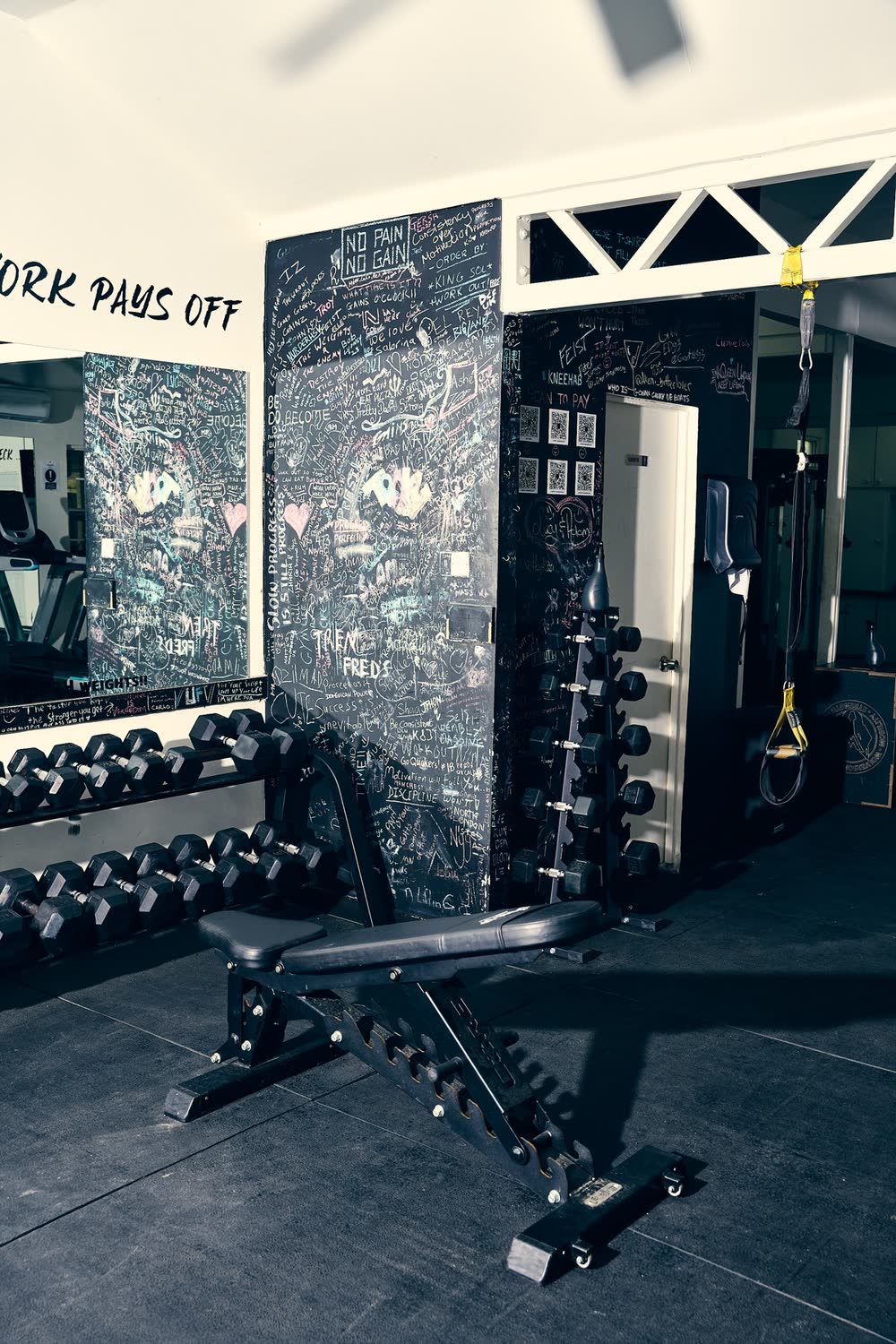 Chalk wall and dumbbells at Holetown