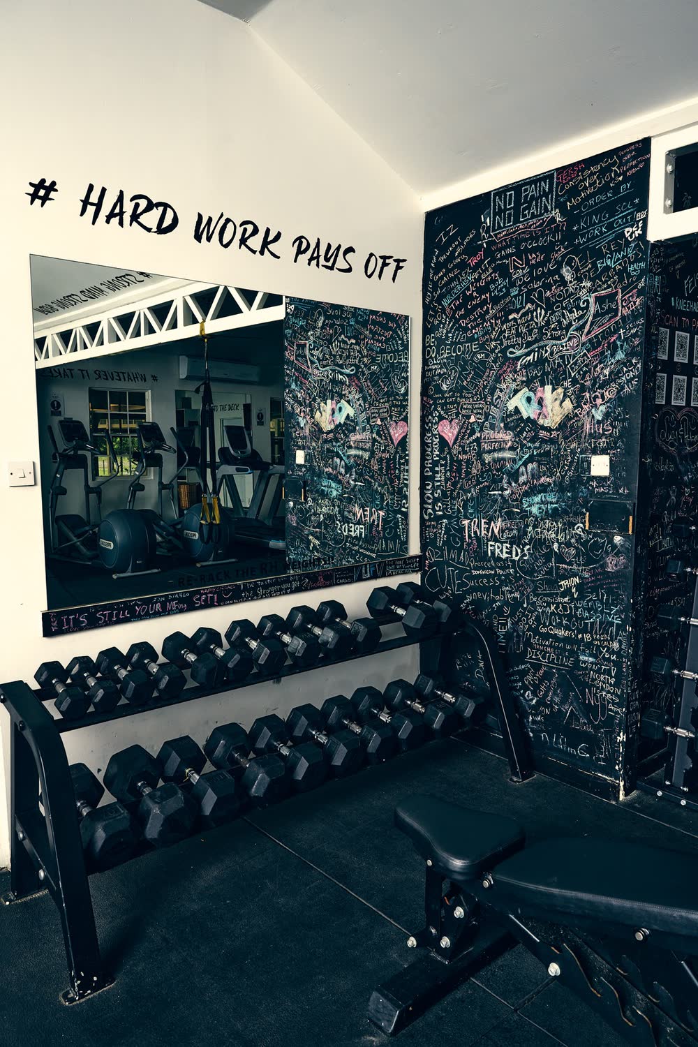 Free weights and Hard Work Pays Off wall at Holetown