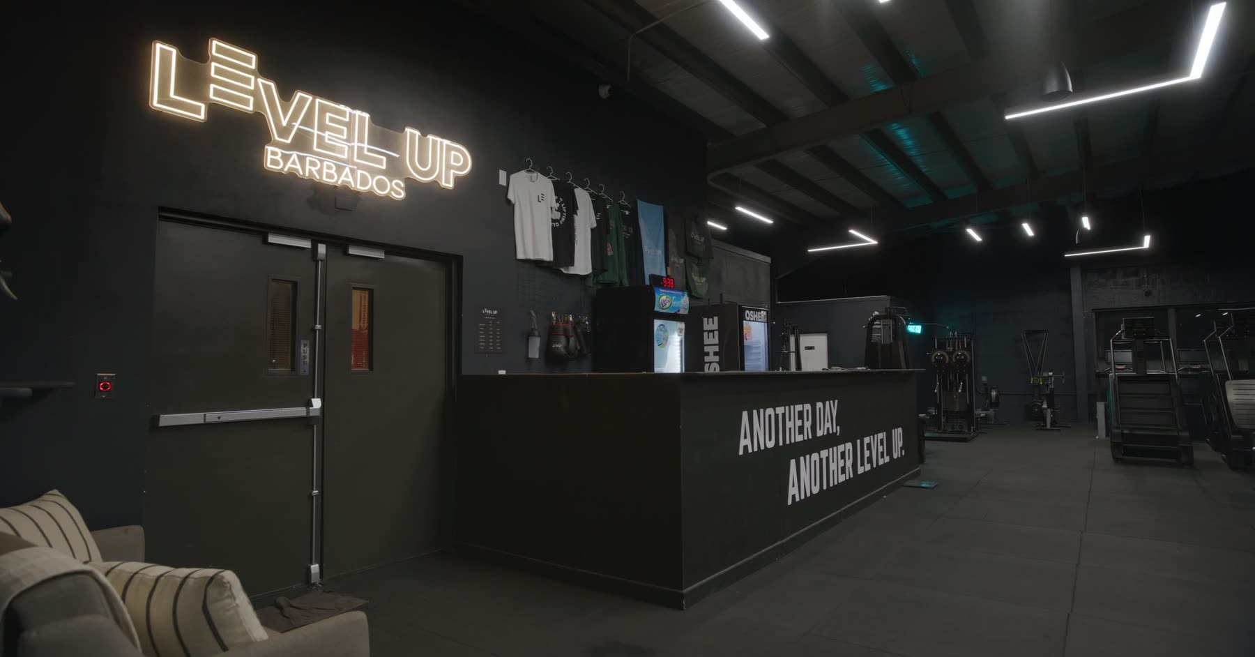 Reception and neon Level Up sign at the Welches flagship